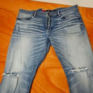 Jordan Craig Denim Blue Jeans With A White Faded Look And Designer Ripped Knees